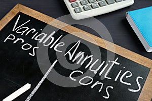 Variable Annuities pros and cons written on a blackboard photo