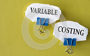 VARIABLE COSTING - the words is printed on a white piece of paper on a yellow background