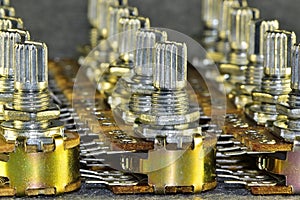 Variable resistors potentiometers, standing in several rows