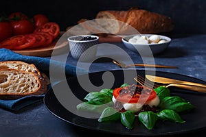 Caprese salad, mozzarella cherry tomatoes, basil, olive oil and balsamic photo