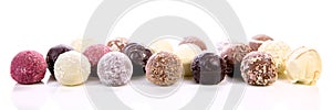 Variation of different chocolate truffles or pralines, white background
