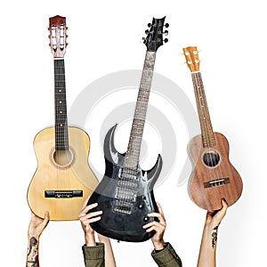 Variation hands holding different guitars