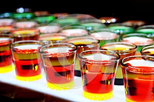 Variation of hard alcoholic shots served on bar counter.