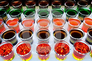 Variation of hard alcoholic shots served on bar counter.
