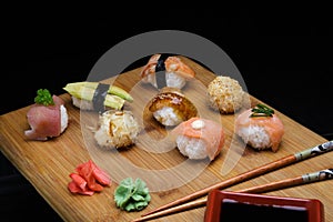 Sushi Set sashimi and rolls served on wooden desk