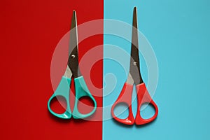 variations of layouts of stationery items, scissors on a coloredred and blue background
