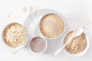 Variaty of raw cereals for breakfast. Oatmeal flakes and steel c