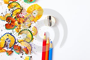 Varicolored pencil, shavings and sharpener on a white