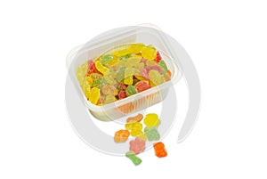 Varicolored sugar candies in small plastic container