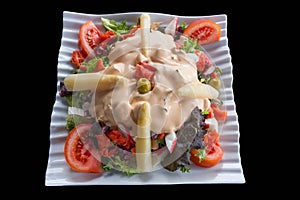 Varied Vegetable Salad topped by an olive isolated photo