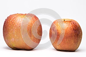 Variegated fresh and wrinkled apples a metaphor for aging. Concept of skin care and freshness