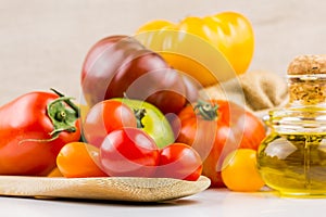 Varieties of colorful tomatos and olive oil
