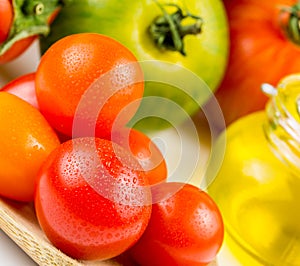 Varieties of colorful tomatos and olive oil