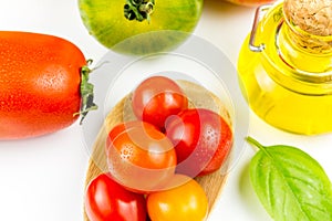 Varieties of colorful tomatos and olive oil