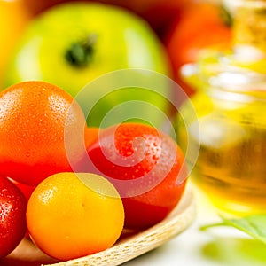 Varieties of colorful tomatos and olive oil