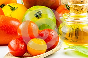 Varieties of colorful tomatos and olive oil