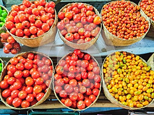 Varieties of fresh organic tomatoes in basket