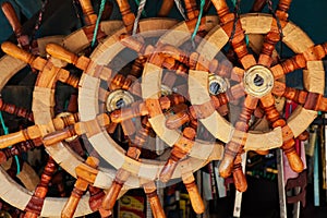 Varieties of traditional old style wooden steering wheels for ships