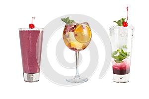 A variety of alcoholic drinks, beverages and cocktails on a white background. Three different drinks in glass goblets decorated