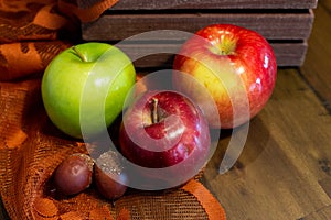 Variety of apples in front of a wooden basket