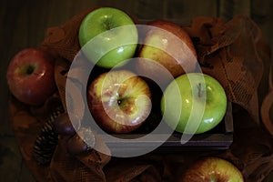 Variety of apples in a wooden basket