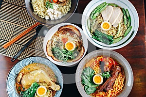 A variety of Asian noodle dishes are displayed on a table