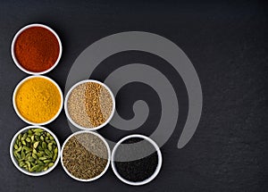 A variety of Asian spices in ceramic bowls top view