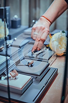 Variety of beautiful jewel ofnamentations on display with flowers in jewellery shop