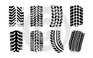 Variety of black tire tread patterns on white tire tracks