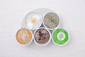 Variety of body scrubs on cotton background.