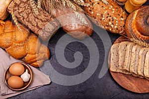 Variety of bread. Assortment of baked bread on grey background.