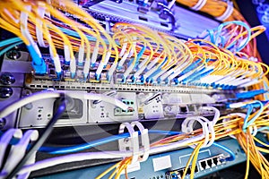 Variety of cables inserted in patch panel of network switch