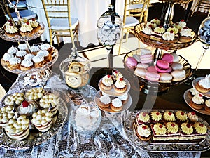 Variety of cakes on plates and glass vessels