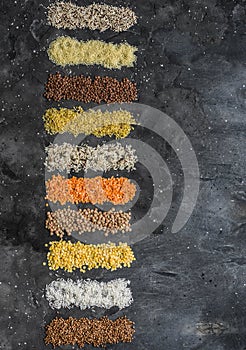 Variety of cereals, grains. Bulgur, rice, quinoa, lentils, couscous, buckwheat on a dark background, top view. Protein food