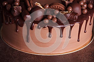 Variety of chocolate decorations and drips of icing on delicious chocolate cake