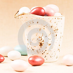 Variety of chocolate eggs in milk jar