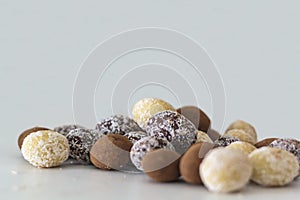 Variety of chocolate eggs on white table