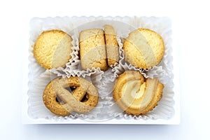 Variety Christmas Danish style butter cookies biscuit placed in the white ruffled paper baking molds in the plastic packaging clos