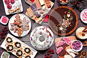 Variety of Christmas holiday desserts and sweets. Above view table scene over a wood background. photo