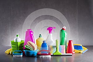 Variety cleaning products on gray background.