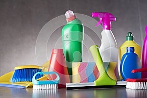 Variety cleaning products on gray background.