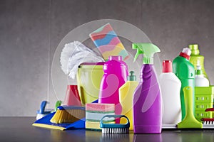 Variety cleaning products on gray background.