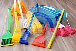 a variety of cleaning supplies, from mops and brooms to sprays and dusters
