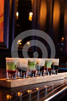 Variety of coffee and mint alcohol cocktail shots in a row