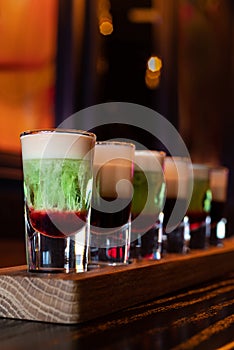 Variety of coffee and mint alcohol cocktail shots in a row