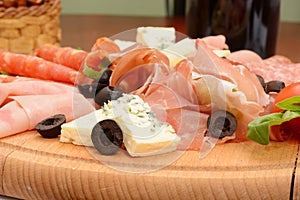 Variety of cold meat, dry cured pork, sausage, salami with cheese and olives