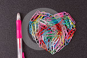 Variety of color paper clips arranged in heart shape