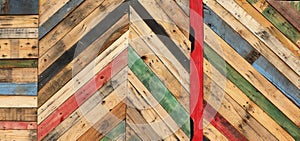 A variety of colored recycled wooden pallets cut and arranged in a herringbone pattern