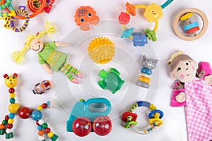 Variety of colorful baby toys on white. top view