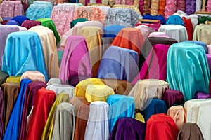 A variety of colorful fabrics covering the pillars